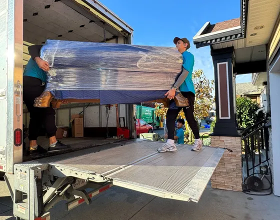 A moving truck being loaded outside a home